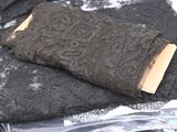 a piece of black lace on top of a piece of black fabric