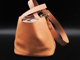 the small bucket bag in tan leather with a leather strap