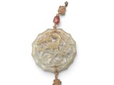 a picture of a necklace with a dragon on it