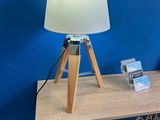 a table with a lamp on top of it next to a book shelf