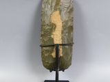 a close up of a rock with a metal stand on a white background