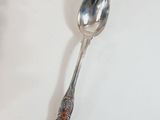 a spoon that is sitting on a white table