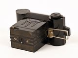 a black camera that is sitting on a white surface