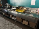 an image of a commercial kitchen with a stainless steel counter top