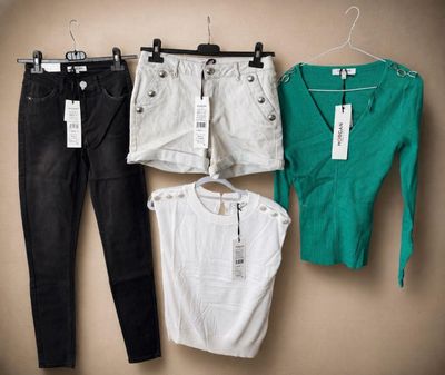three pairs of black, white, and green clothes hang on a hanger