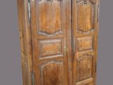 an old wooden armoire with two doors and two drawers