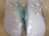 a pair of shoes in a plastic bag on a table