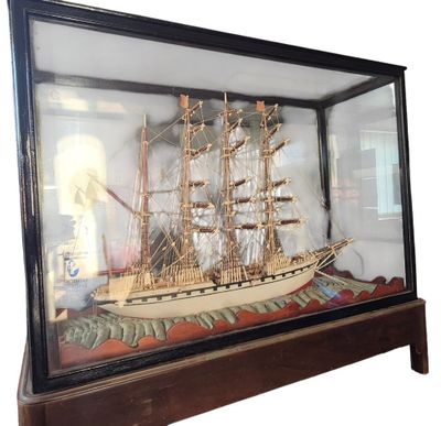 a glass case with a model of a ship in it