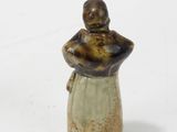 a small figurine of a woman holding a baby