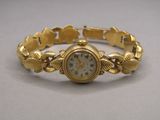 an image of a gold bracelet watch with roman numerals on it