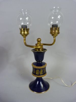 an image of a blue and gold table lamp with two glass globes on it