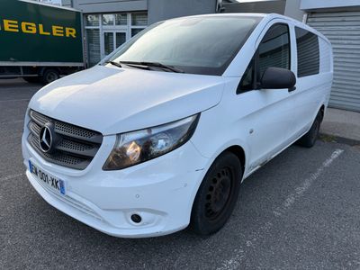 a white van parked in a parking lot next to a building