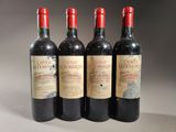 four bottles of wine are lined up in a row on a table
