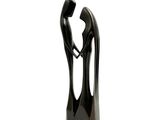 une sculpture noire représentant un homme et une femme se tenant la main