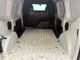 the back of a white van with the door open and the cargo compartment in the back