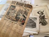 several old newspapers are stacked on top of each other on a table