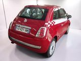 a small red car that is parked in a room