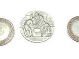 three different types of coins are shown on a white surface