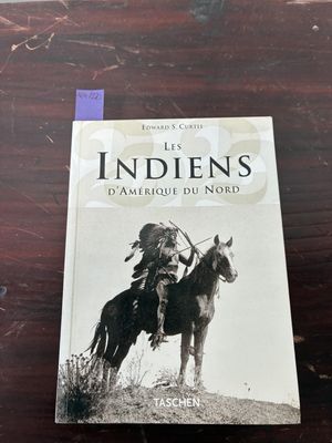 the book is sitting on a table with a horse and a person on it