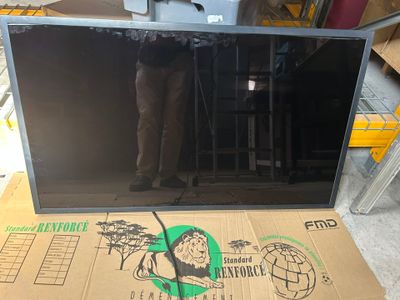 a picture of a man standing in front of a television screen