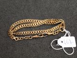 a close up of a gold chain with a tag on it