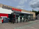 un parking devant lequel se trouve un distributeur automatique de tickets de stationnement