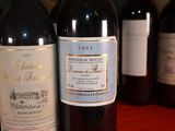 several bottles of wine are lined up on a table