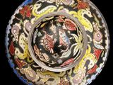 a bowl with a design on it on a black background