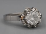 a close up of a diamond ring on a gray surface