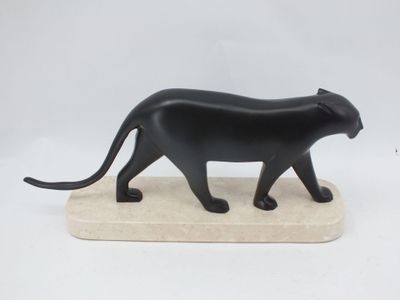 statue of a black cat on a marble base on a white background