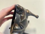 a person holding a small metal object in their hand