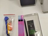 a cell phone sitting on a table next to other items
