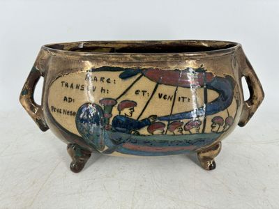 un pot en céramique orné d'un motif, posé sur une table