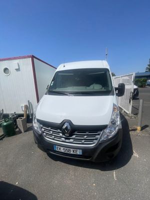the white van is parked in the parking lot next to a trailer