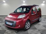 the small red van is parked in a large room