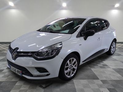 the white car is parked on a checkered tile floor