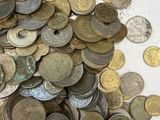 a pile of coins on a table with a white background