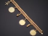 a close up of a gold bracelet with coins on it