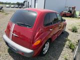 a small red car parked in front of a building