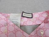 a close up of a label on a pink dress