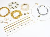many different types of necklaces and bracelets laid out on a table