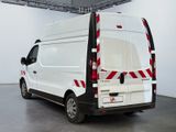 a white van with red stripes parked in a room