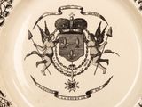 a black and white plate with a coat of arms on it