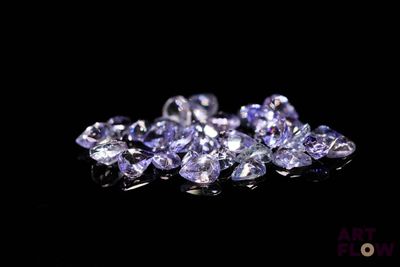 a close up of a bunch of purple diamonds on a black surface
