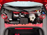 a red car with its hood open and the engine in it ' s trunk