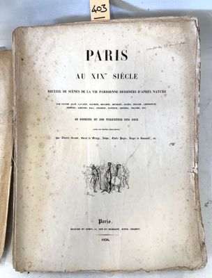 an old book sitting on top of a table next to an open book