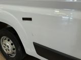 a picture of a white truck parked in a showroom