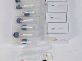 several vials of different sizes and colors are sitting on a white surface