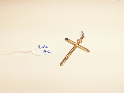 a cross on the table next to a tag with a name written on it