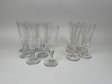 six clear wine glasses sitting on top of a white table